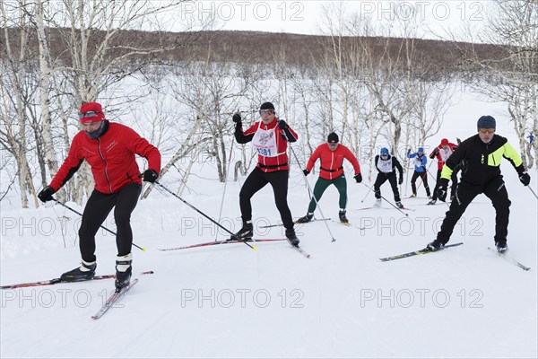 PETROPAVLOVSK CITY, KAMCHATKA PENINSULA, RUSSIAN FAR EAST, FEBRUARY 10, 2018: Skiers running on ski track in cross-country winter forest. All-Russia mass ski race, Ski Track of Russia