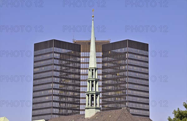 Top of Essen Cathedral, with the town hall behind it. With a height of 106 metres and 69, 000 square metres of office space, Essen City Hall is one of the largest in Germany, Essen, North Rhine-Westphalia, Germany, Europe