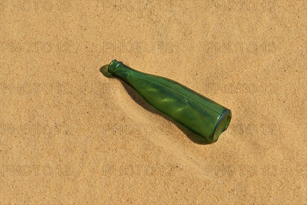 Green bottle lying in the sand in the desert, Matruh, Great Sand Sea, Libyan Desert, Sahara, Egypt, North Africa, Africa