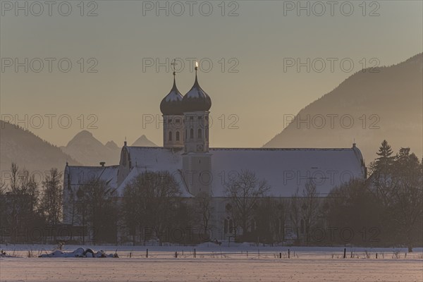 Monastery and basilica in the evening light in front of mountains, snow, winter, Benediktbeuern Monastery, Alpine foothills, Upper Bavaria, Bavaria, Germany, Europe