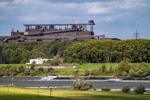 Rhine at Duisburg-Beeckerwerth, freighter loaded with coal, Oxygen steelworks 2 Industrial backdrop of the ThyssenKrupp Steel steelworks in Bruckhausen, North Rhine-Westphalia, Germany, Europe