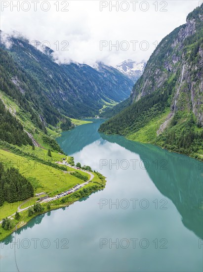 A mirror-like mountain lake nestled in a green, mountainous landscape, Stilluptal, Austria, Germany, Europe