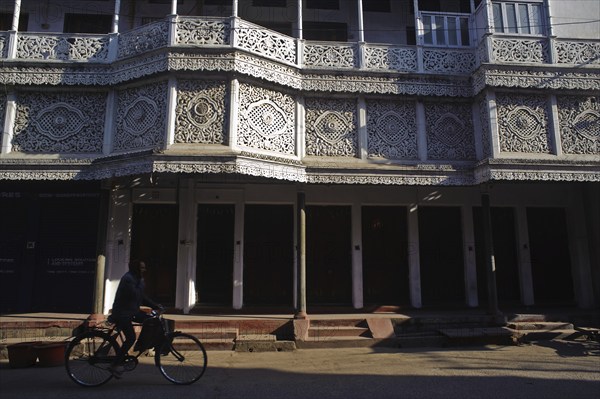 Cyclist in front of a ornate house, street scene at Daltonganj, Jharkhand, India, Asia