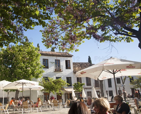 People sitting outside cafes historic square Placeta de San Miguel Bajo in the Albaicin district, Granada, Spain, Europe