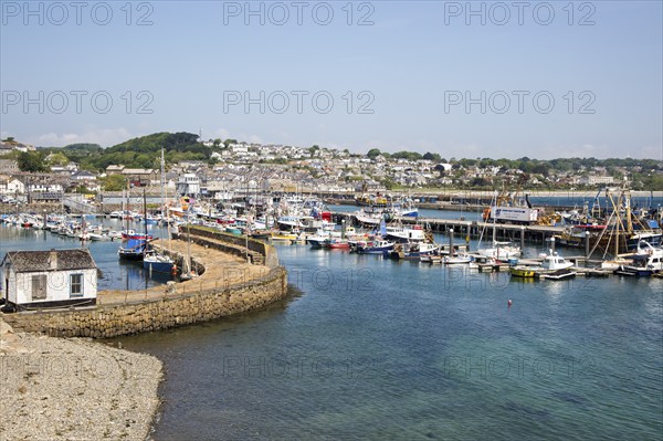 Boats at moorings in the harbour of fishing port of Newlyn, Cornwall, England, UK