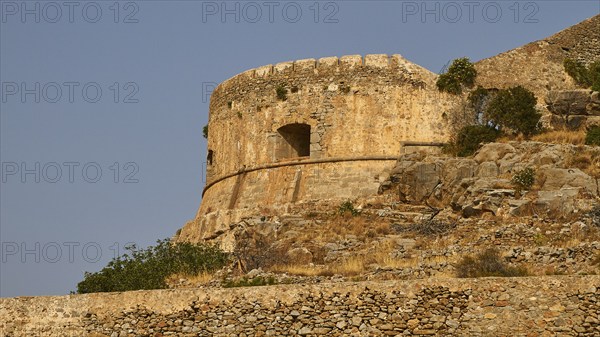 Old round stone tower on rocky ground with clear sky, Venetian Sea Fortress, Leper Island, Spinalonga, Elounda Bay, Mirabello Bay, East Crete, Crete, Greek Islands, Greece, Europe