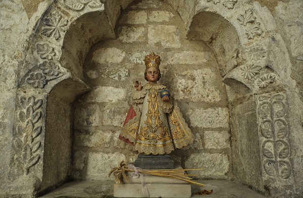 Copy of a statuette representing Jesus Christ as a child. It is called the Little Jesus of Prague. Seen in the Airvault church France