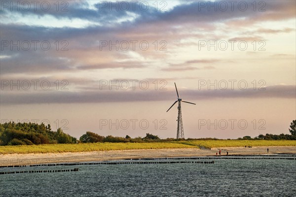 Sunset on the Baltic Sea beach, Wustrow beach in the evening light with clouds and windmill, evening mood, Baltic seaside resort Wustrow, Fischland-Darß-Zingst peninsula, Mecklenburg-Western Pomerania, Germany, Europe