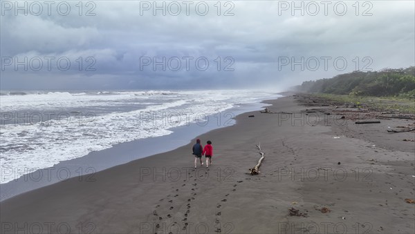 Two tourists on the beach, coast with rainforest, Tortuguero National Park, Costa Rica, Central America