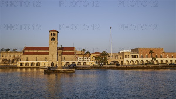Church at the harbour, surrounded by calm sea and clear blue sky at morning light, Church of the Annunciation of the Blessed Virgin Mary, bell tower, harbour area, Rhodes Town, Rhodes, Dodecanese, Greek Islands, Greece, Europe