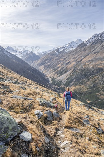 Hiker on hiking trail, snow-covered mountains, Ötztal, Tyrol, Austria, Europe