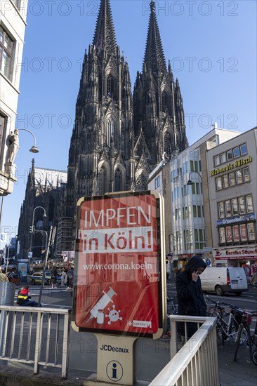 Advertising for the corona vaccination, campaign on Citylight posters at Cologne Cathedral, view of the west façade, on the north tower of Cologne, Germany, Europe