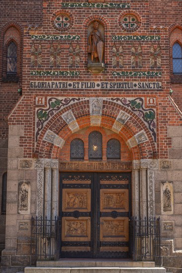 Odense, early Gothic St Albani Church, Roman Catholic church, entrance portal with wood carvings, brick building, Latin inscription, statues, Fyn, Fyn Island, Denmark, Europe