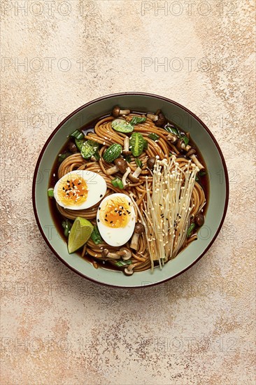 Soba, buckwheat noodles, with enoki mushrooms, shimeji and boiled egg, top view, homemade, no people
