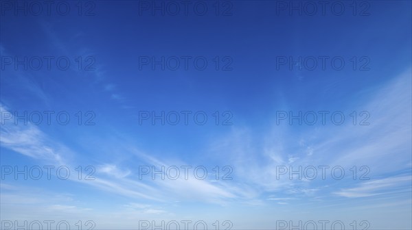 Clear Blue Sky with Whispy White Clouds, Perfect for Nature and Weather Backgrounds