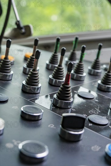 Close-up of a control panel with various levers and buttons, surroundings blurred, track construction Hermann Hesse railway, Calw district, Black Forest, Germany, Europe