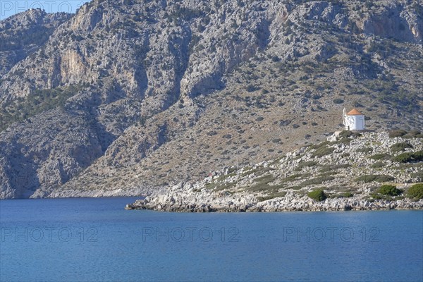 Old windmill on a rock, Bay of Panormitis, Symi, Dodecanese, Greece, Europe