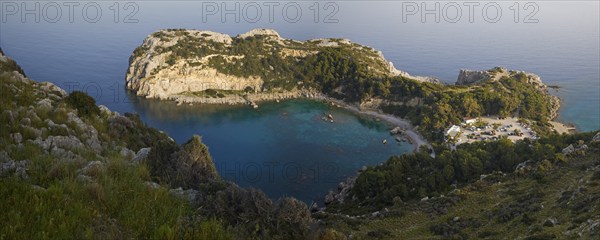 Panoramic view of a rocky bay surrounded by wooded hills and clear, calm waters, Anthony Quinn Bay, Vagies Bay, Rhodes, Dodecanese, Greek Islands, Greece, Europe