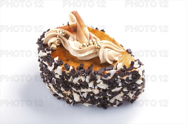 Cake with chocolate chips and cream decorations isolated on white background. close up