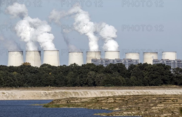 View from the Baltic Sea to the Jänschwalde lignite-fired power plant of LEAG Lausitz Energie Kraftwerke AG. The Cottbus Baltic Sea is a project in which the former Cottbus-Nord opencast lignite mine is flooded with water from the River Spree, Lakoma, 02/10/2021