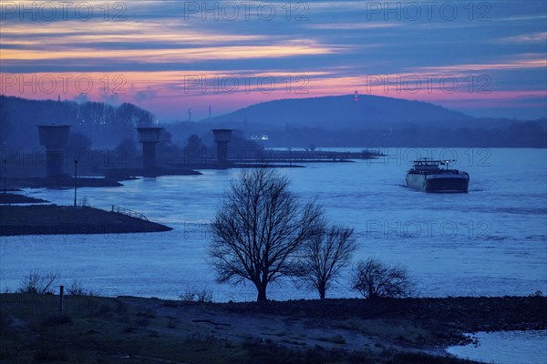 Rhine at Duisburg-Bruckhausen, towers of the water extraction facilities of ThyssenKrupp Steel steelworks, cargo ship, winter, Duisburg, North Rhine-Westphalia, Germany, Europe