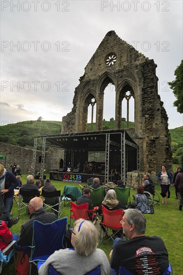 Visitors at an open-air concert in the evening, ruin, Abbey Farm, Llangollen, North Wales, Wales, Great Britain