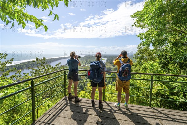 Tourists look out over the rainforest from Cerro Tortuguero, Tortuguero National Park, Costa Rica, Central America
