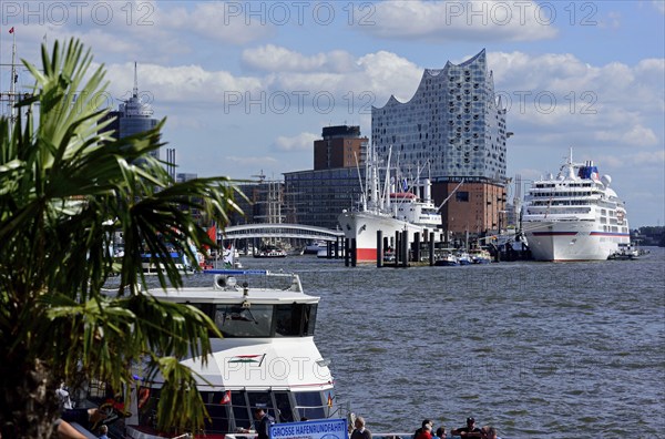 Europe, Germany, Hanseatic City of Hamburg, Elbe, Elbe Philharmonic Hall, glass facade, harbour tour with harbour ferry, many tourists, passenger ship Europa at the Überseebrücke, Europe