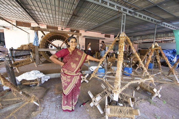 Indian worker, 59 years old, in the spinning mill of the Labourers Coir Mats and Mattings Cooperation, coir mat production, Muhamma, Alappuzha, Kerala, India, Asia