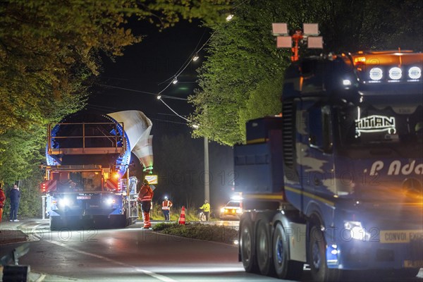 Transport of a 68 metre long, 22 tonne blade of a wind turbine, here in Schwelm, with a self-propelled Blade-Lifter vehicle, over a 40 km long route, over 2 nights, in the Bergisches Land, through towns, villages, over country roads, narrow through roads, to the construction site of the wind turbine near Hagen, North Rhine-Westphalia, Germany, Europe