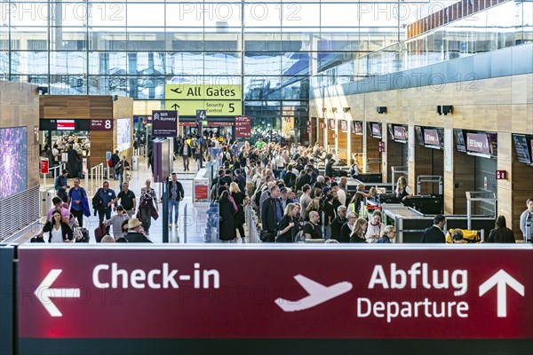 Berlin-Brandenburg BER Airport. Passengers in Terminal 1 waiting for check-in and security control in front of departure. Berlin, Germany, Europe