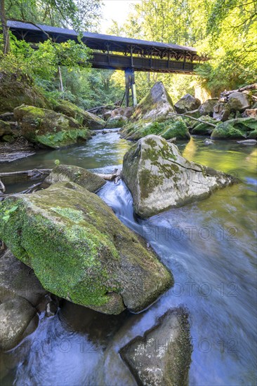 The Irrel Waterfalls, rapids in the lower reaches of the Prüm, covered wooden bridge for hikers, between Prümzurlay and Irrel, in the Eifel district of Bitburg-Prüm, Rhineland-Palatinate. Germany