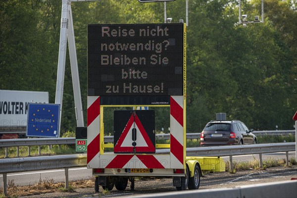 German-Dutch border at Emmerich-Elten, A3 motorway, signal board asks travellers to only make necessary journeys to the Netherlands, effects of the corona crisis in Germany