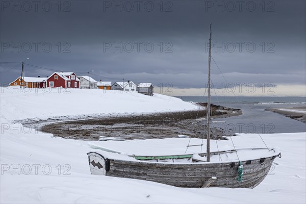 Old boat on the beach, houses, village, coast, sea, snow, winter, clouds, Kramvik, Varanger Peninsula, Norway, Europe