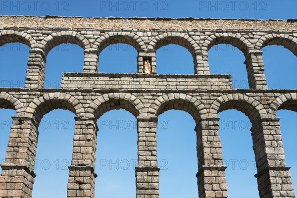 Ancient stone aqueduct with several arches in front of a blue sky, Aqueduct, Segovia, Castilla y León, Leon, Spain, Europe