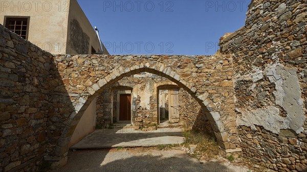 A building with stone arches and ancient walls illuminated by daylight, Venetian Sea Fortress, Leper Island, Spinalonga, Elounda Bay, Mirabello Bay, East Crete, Crete, Greek Islands, Greece, Europe