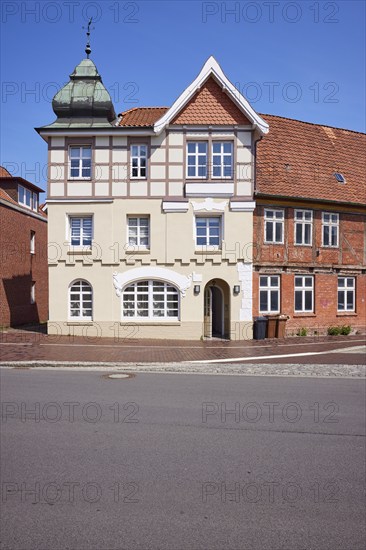Listed residential building with imitation half-timbering, Welscher bonnet and triangular gable against a blue sky in Stade, Hanseatic city, district of Stade, Lower Saxony, Germany, Europe