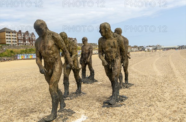 'Walking Men' artwork bronze sculptures by Laurence Edwards, South Beach, Lowestoft, Suffolk, England, UK July 2024