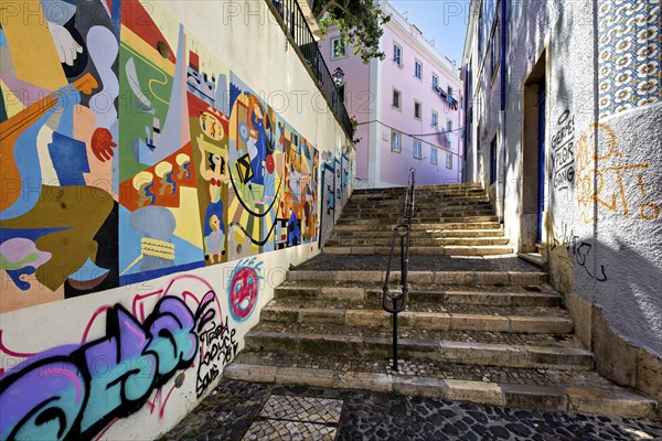 A colorful street art mural lines a staircase in an urban alleyway, adding vibrancy to the city, Alfama, Lisbon