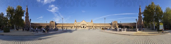 Spacious piazza with impressive architecture and towers under a bright blue sky, Seville