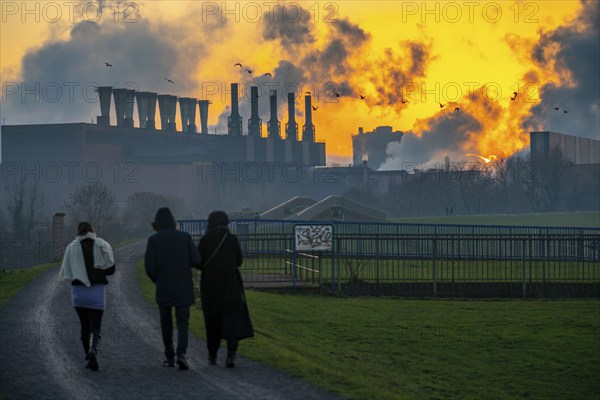 Rhine at Duisburg-Bruckhausen, steelworks Thyssenkrupp Steel, walkers on the Rhine dyke, winter, Duisburg, North Rhine-Westphalia, Germany, Europe
