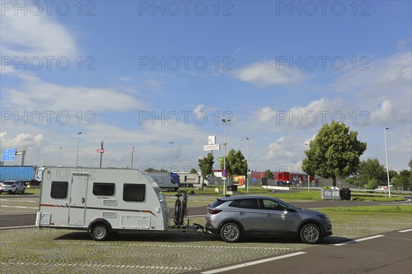Car with caravan standing on a motorway service area, Tank und Rast, Caravan, service area near Linz, Austria, Europe