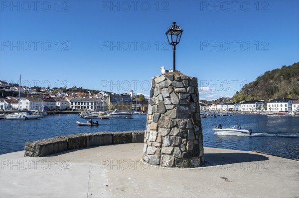 At the seaside in Risor, a traditional village with wooden white houses at the southern norwegian coast, Norway, Europe