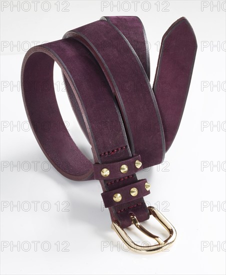 Leather belt in front of a white background, studio shot