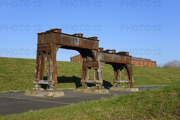Rusty metal structures on an abandoned industrial site with a green meadow and blue sky, Ilseder Hütte, Ilsede, Peine district, Lower Saxony, Germany, Europe
