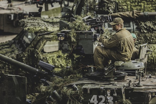 A soldier sits on a tank, taken as part of a Bundeswehr exercise with armed forces from Norway and the Czech Republic during the 'Wettiner Schwert' exercise as part of Quadriga 2024 in the training town of Schnöggersburg, 8 April 2024