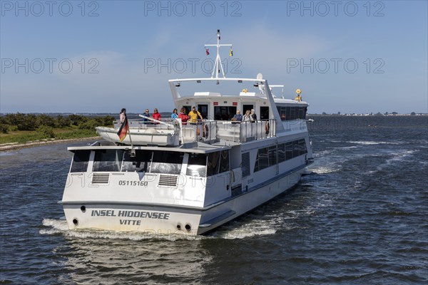 Island ship with passengers on the upper deck sailing across the sea on a sunny day, Rügen