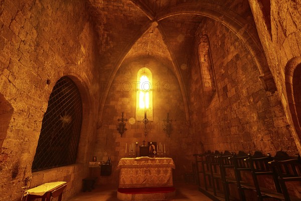 Chancel of the monastery church, church interior with warm evening light, altar and cross, Gothic atmosphere, Monastery of Our Lady of Mount Filerimos, Filerimos, hill not far from Rhodes Town, Ancient State of Ialyssos, Rhodes, Dodecanese, Greek Islands, Greece, Europe