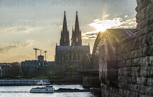 Panorama, Skyline of Cologne, with the cathedral and the railway bridge, Hohenzollern Bridge, on the Rhine, sunset, cargo ship, North Rhine-Westphalia, Germany, Europe