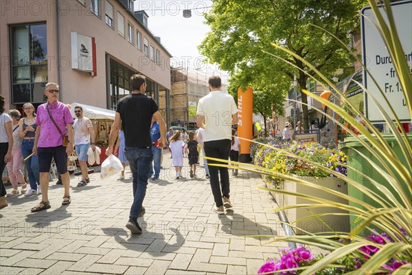 Lively street scene with people walking, surrounded by shops and flowers in a summer atmosphere, garden fair and ceramics, Nagold, Black Forest, Germany, Europe